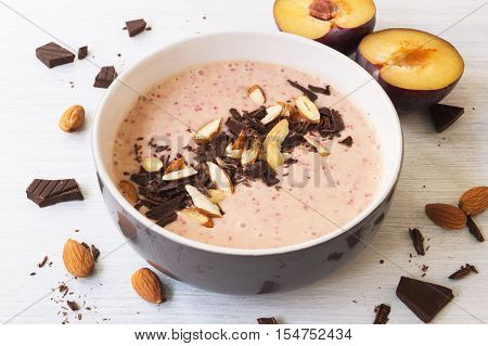 Plum chocolate fruit smoothie bowl. Healthy smoothie breakfast selective focus horizontal