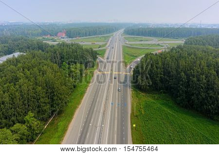 Tyumen, Russia - July 22, 2016: Bird eye view onto two-level outcome of roads on Irbit path with bypass way. There is smog in air