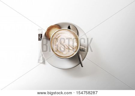 Cappuccino above with spoon. Isolated on white background.