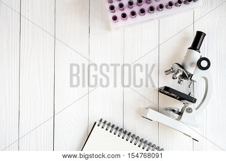 doctor workplace at wooden table with microscope in lab top view no one