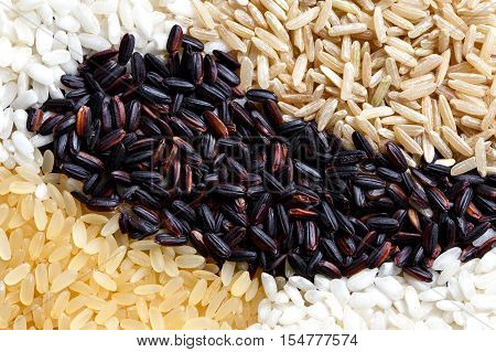 Abstract Pattern Made Of Black, White, Brown And Parboiled Rice From Above.