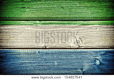 Flag of Sierra Leone painted on old grungy wooden background: 3d illustration