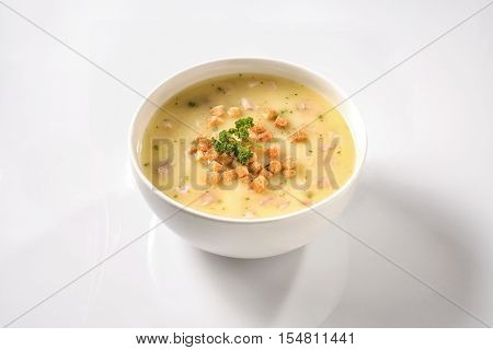 Fresh vegetable chicken stew with croutons on white background