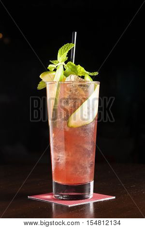 Cocktail decorate with cucumber and mint against black background