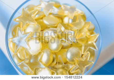 Close up image of yellow marbles on blue background