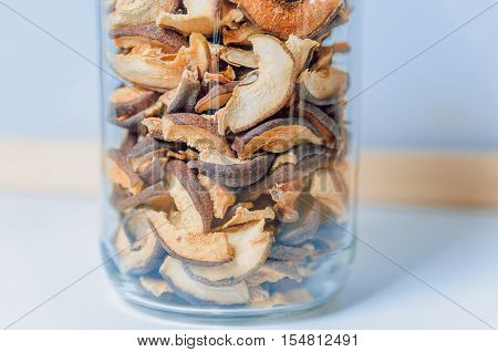Dried apples in bank on a light background