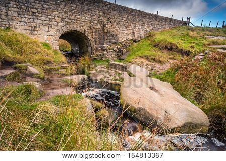 Upper Burbage Bridge East, with the Burbage Brook flowing under it, located in the Peak District National Park