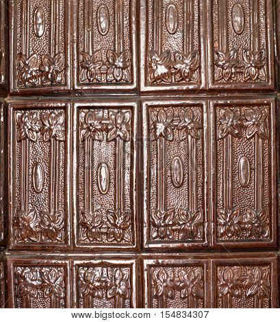 Brown tiles on the stove surface. Close up.