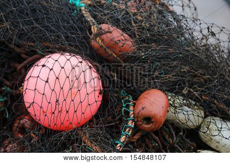 Black fishing net red and white buoys