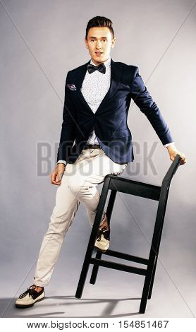 young handsoman businessman fooling aroung with chair, woundering gesturing, lifestyle people concept close up