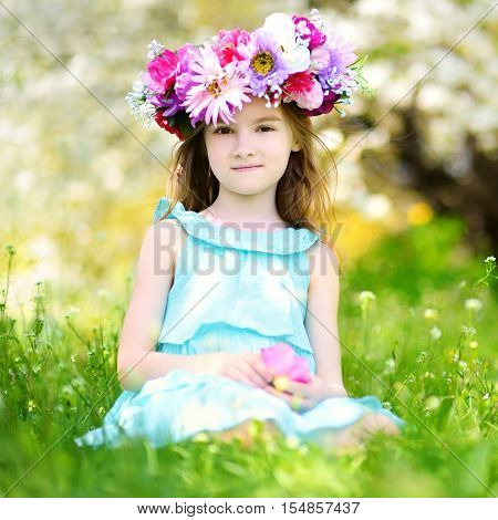 Adorable Little Girl In Blooming Cherry Garden