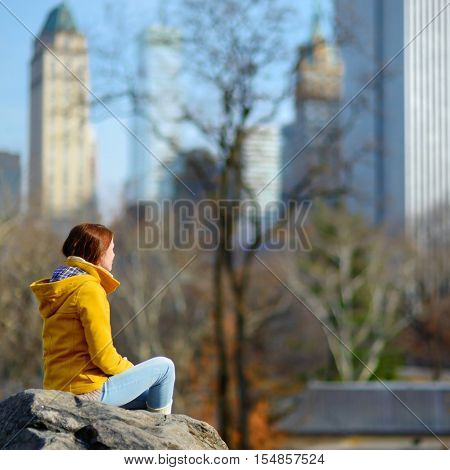 Young Woman Looking At Skyscrapers In Central Park