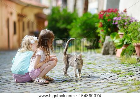 Two Adorable Little Sisters And A Cat