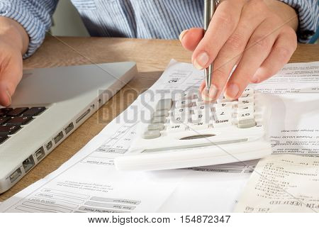 Bookkeeping With Calculator, Pen And Laprop Computer
