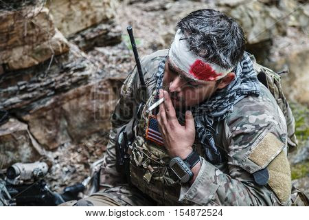 Wounded army ranger machine gunner in the mountains