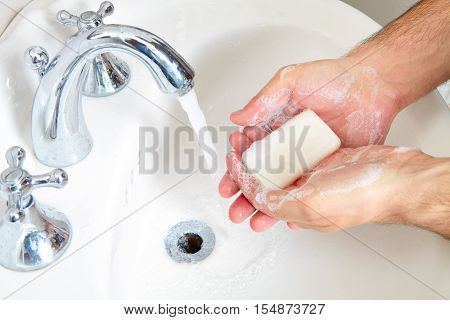 Male Washing Her Hands In Bathroom