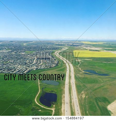 Aerial view of canola farm fields, city roads and buildings.  Text 