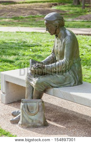 Springfiled Missouri USA- May 18 2014. Reading woman statue in Nathanael greene park Springfield Missouri.
