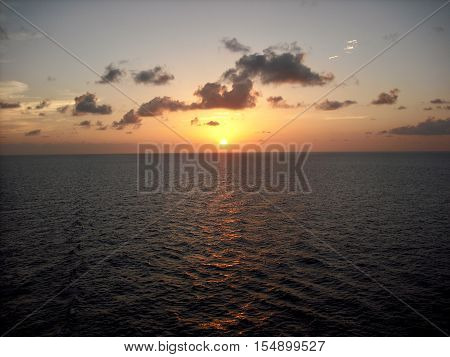 Sunset over the ocean from a ship