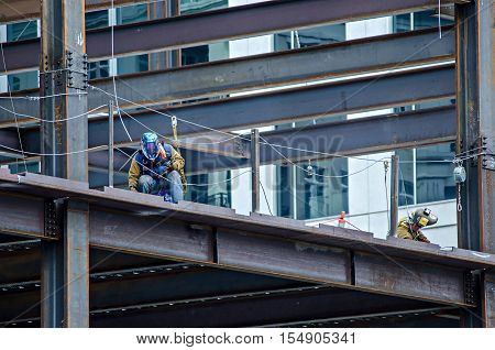 a construction worker working on highrise building
