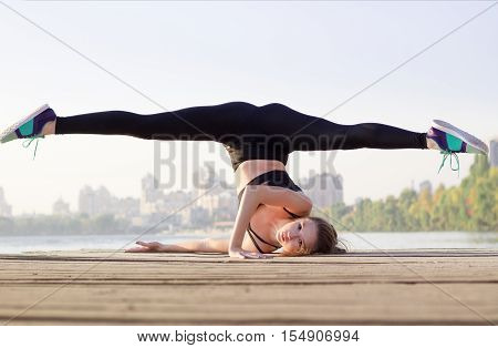 Sporty Woman Doing Streching Yoga Exercise During Training Workout Outdoor