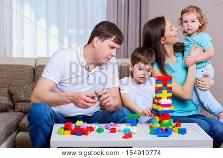 Family playing board game at home.Happy family