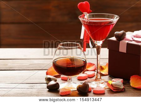 Alcoholic drinks for the festive party. Chocolate candy hearts. Gift for a holiday. Date on Valentines Day