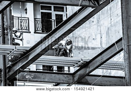 a construction worker working on highrise building