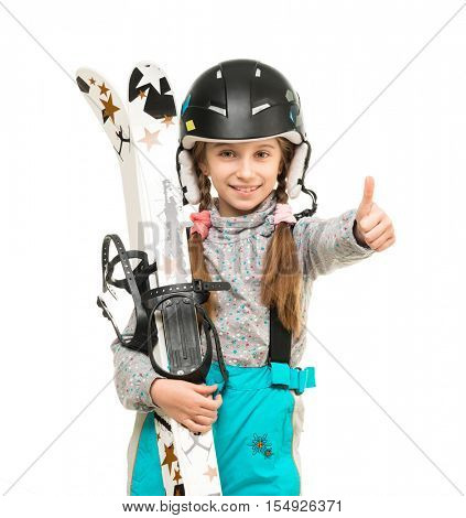 smiling little girl in helamet holding skis with thumb up isolated on white background