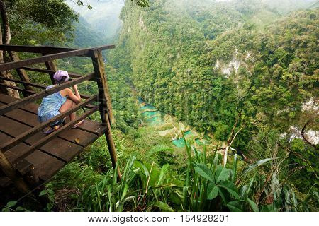 Photographer on the lookout point on the Cascades National Park in Guatemala Semuc Champey