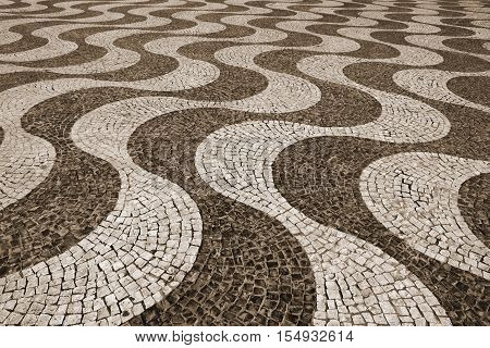 Portugal. Lisbon. Typical portuguese cobblestone handmade pavement. In Sepia toned. Retro style
