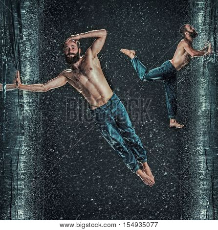 The male break dancer in water on dark background. Collage