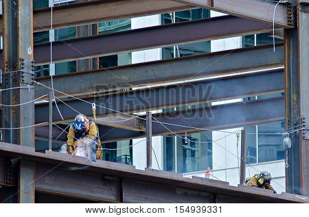 a construction worker working on highrise building