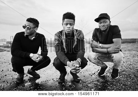 Three Rap Singers Band On The Roof. Black And White Photo