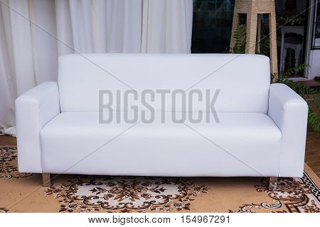 Living room with sofa in front of a wall in white