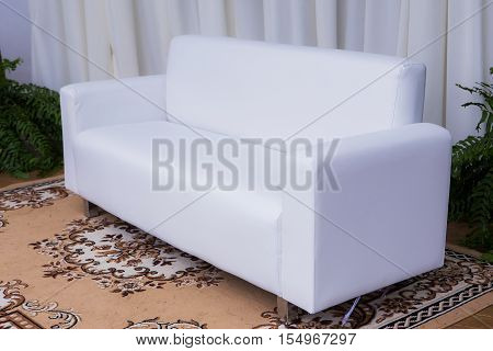 Living room with sofa in front of a wall in white