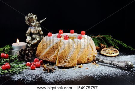 Christmas bundt cake with red berries with a candle