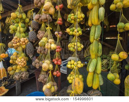 Tasty fresh colorful fruit hanging on a market stall in a small town.