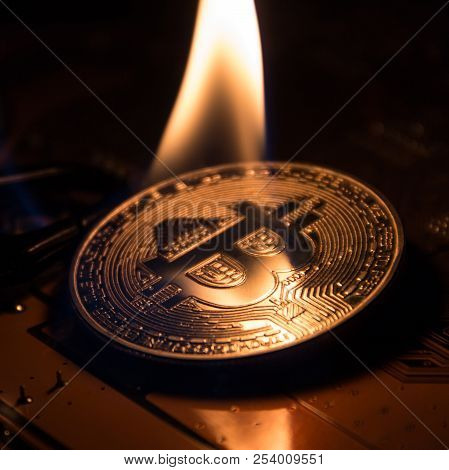 The Fire Is On A Silver Bitcoin Like A Candle. A Square Picture.