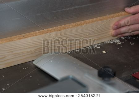 Working Wooden Board With A Planing Machine In The Workshop - Closeup