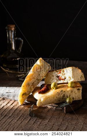 Sliced Bread Ciabatta And Extra Virgin Olive Oil On Olive Wood Cookware Background. Wooden Desk. Ita