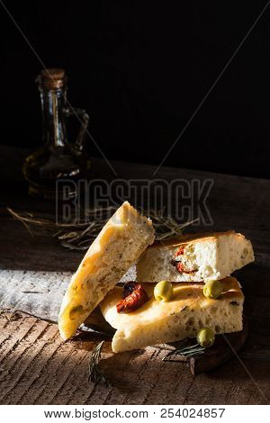 Sliced Bread Ciabatta And Extra Virgin Olive Oil On Olive Wood Cookware Background. Wooden Desk. Ita