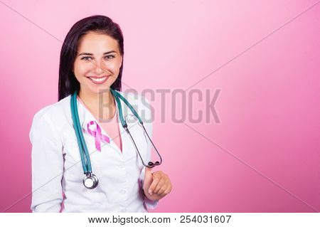 Beautiful Girl Doctor, Nurse And Surgeon With Breast Cancer Prevent Concept On The Pink Background S