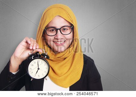 Young Businesswoman Holding A Clock