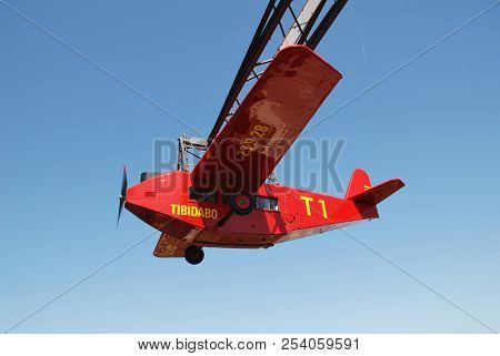 BARCELONA, SPAIN - APRIL 18, 2018: The iconic El Avio aeroplane ride at the Tibidabo Amusement Park on Mount Tibidabo. The ride has been operating since 1928.