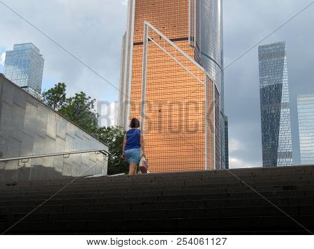 Woman Goes Up The Stairs On Background Of Skyscrapers. Moscow City Landscape, Urbanisation Concept, 