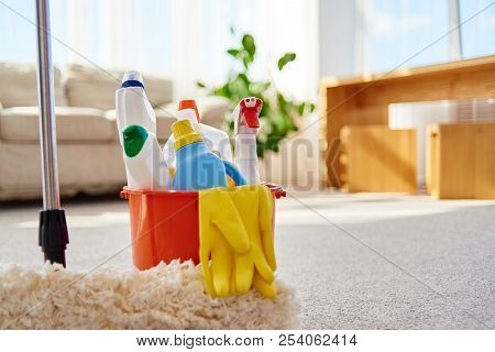 Cleaning Set For Different Surfaces In Orange Bucket And Mop On Floor In Living Room, Copy Space. Cl