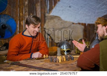 Two Men Playing Popular Strategy Board Game - Tafl