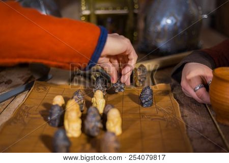 Two Men Playing Popular Strategy Board Game - Tafl