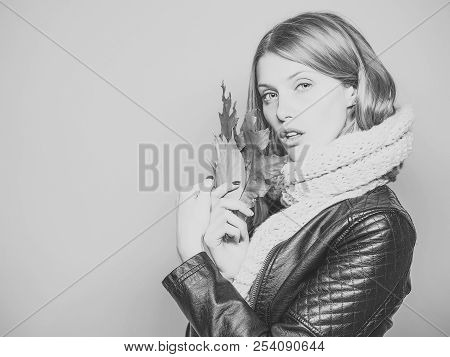 Woman With Autumn Leaves In Leather Jacket And Scarf On Blue Background, Copy Space